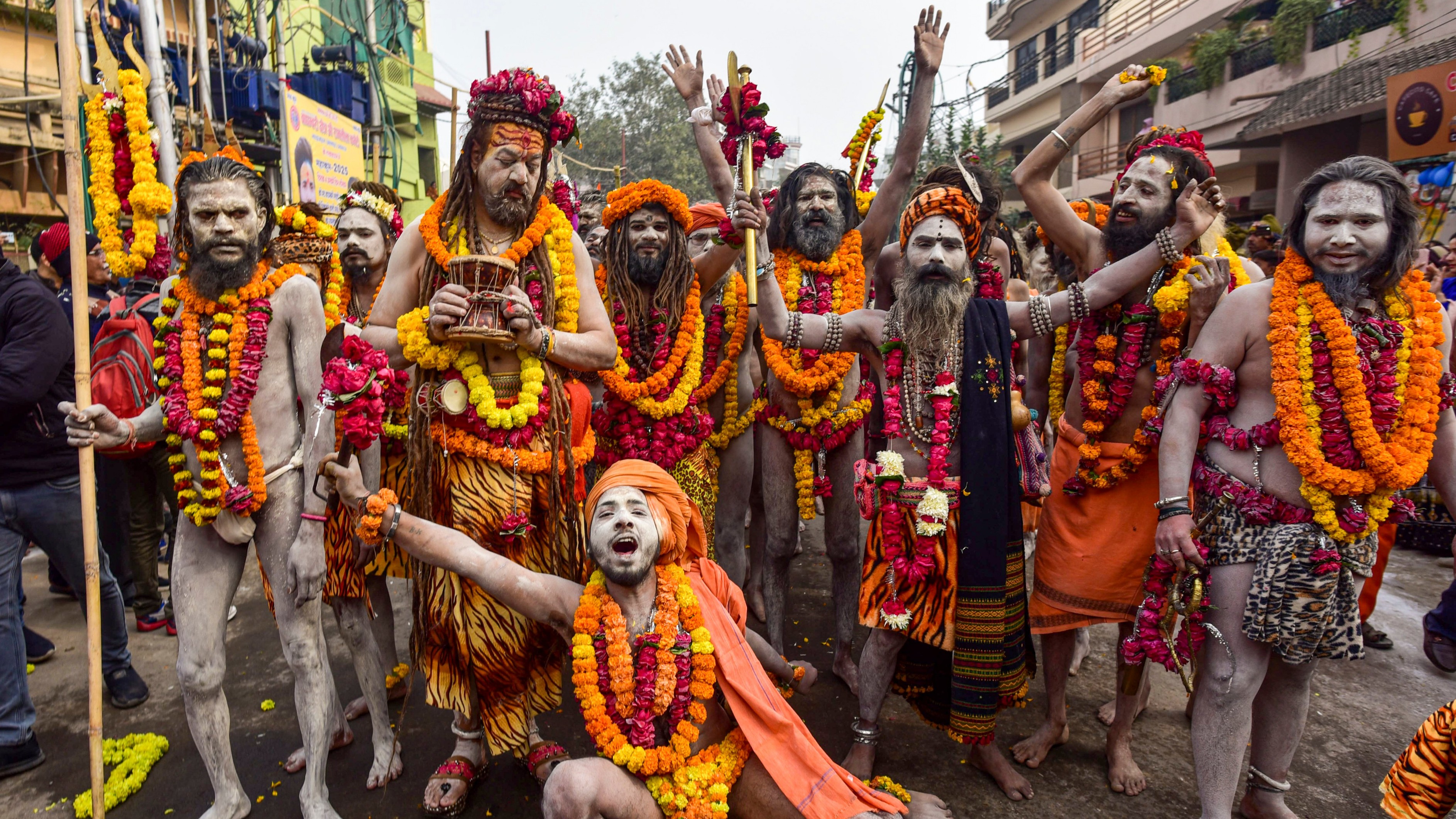 Naga Sadhus pose for a photo as they walk towards Sangam ahead of Maha Kumbh Mela 2025 in Prayagraj.