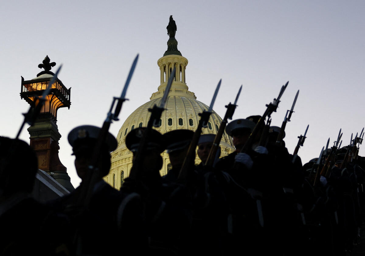 Honour guard members march as the casket of Jimmy Carter, the former U.S. president who died on Dec. 29 at the age of 100, arrives so he can lie in state at the US Capitol building, in Washington, US. 
