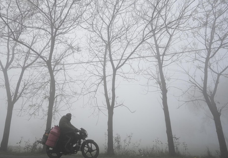 Commuters on a foggy winter morning, on the outskirts of Amritsar, Thursday, Jan. 9, 2025.