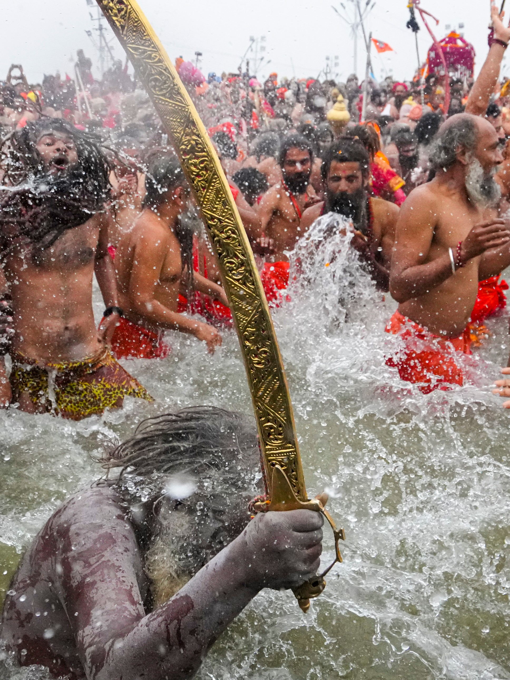 Sadhus take a holy dip during the Maha Kumbh in Prayagraj.