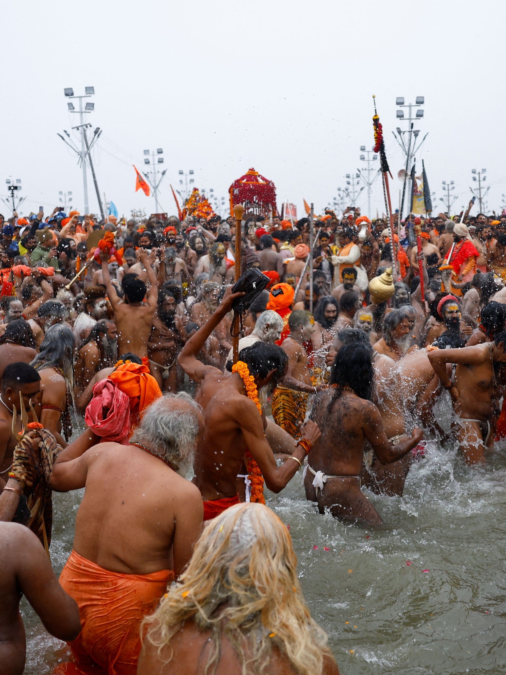Carrying spears and tridents, Naga sadhus with their bodies smeared in ash moved in a procession with some riding horses as they made their way to the Shahi Snan.