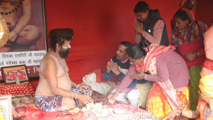 Devotees seeking the blessings of Naga Sadhu Pramod Giri Maharaj at the Shri Shambhu Panchayati Atal Akhara, MahaKumbh 2025, at Prayagraj, Uttar Pradesh.