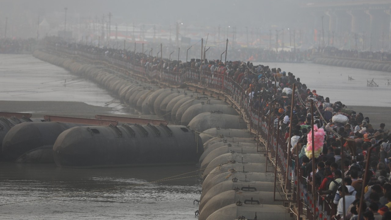 Devotees walking on a pontoon bridge from the Sangam at the MahaKumbh 2025 at Prayagraj, Uttar Pradesh.