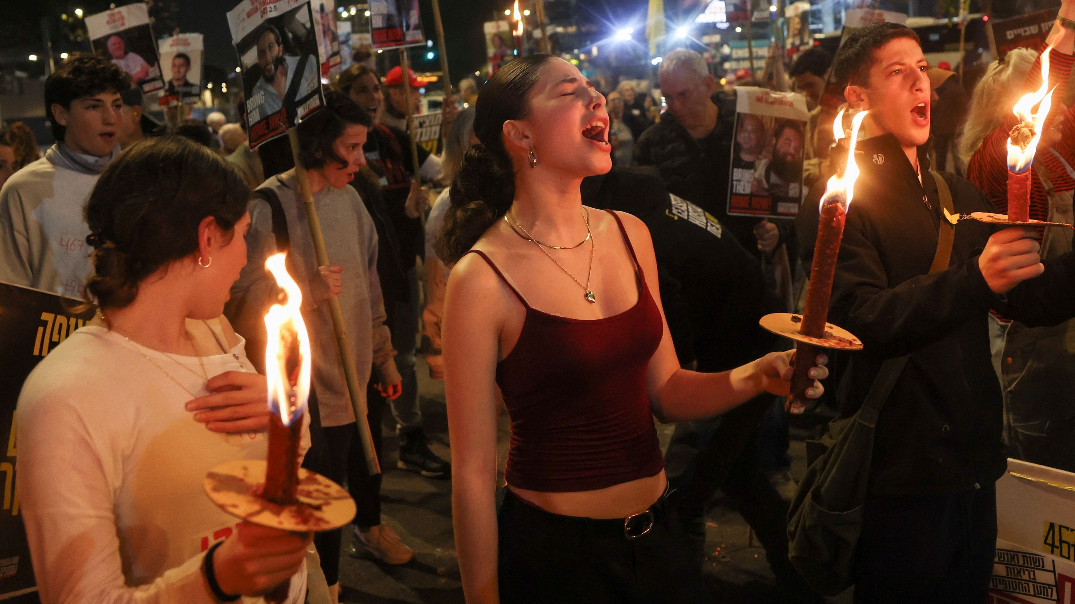Supporters of Israeli hostages hold torches as they attend a protest to demand a deal to bring every hostage home at once amid Gaza ceasefire negotiations in Tel Aviv, Israel.