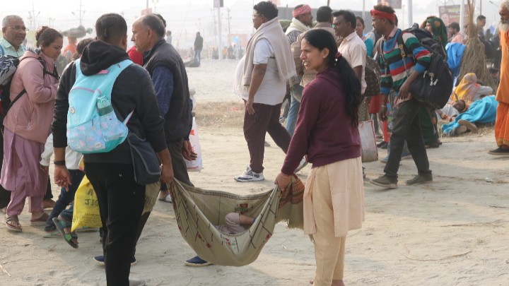 A couple with their child on their way to the Sangam at the MahaKumbh 2025 at Prayagraj, Uttar Pradesh.