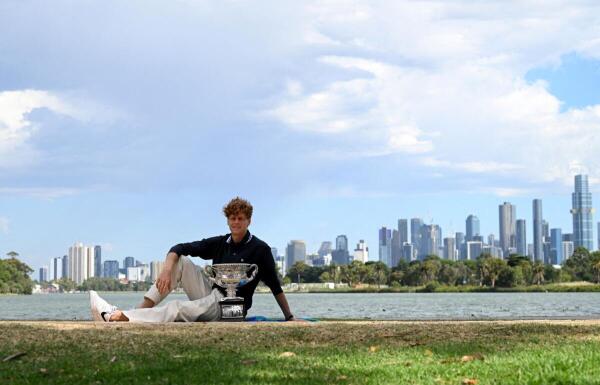 Italy's Jannik Sinner, the men's singles winner of the Australian Open poses with the  trophy.