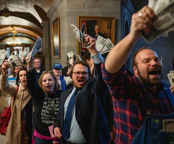 Protesters taunt Tennessee Republican Governor Bill Lee as he makes his way to a press briefing on the last day of the special legislative session, where the universal school voucher program, Hurricane Helene relief, and immigration reforms supporting U.S. President Donald Trump's policies all passed the House and Senate and will become law, at the Tennessee State Capitol building in Nashville, Tennessee
