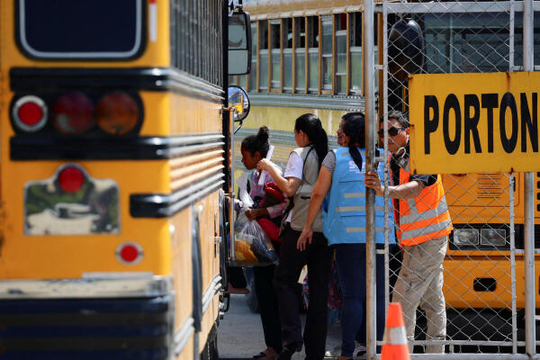 Honduran migrants deported from the United States board a bus at the Center for Attention to Returned Migrants, in San Pedro Sula, Honduras.