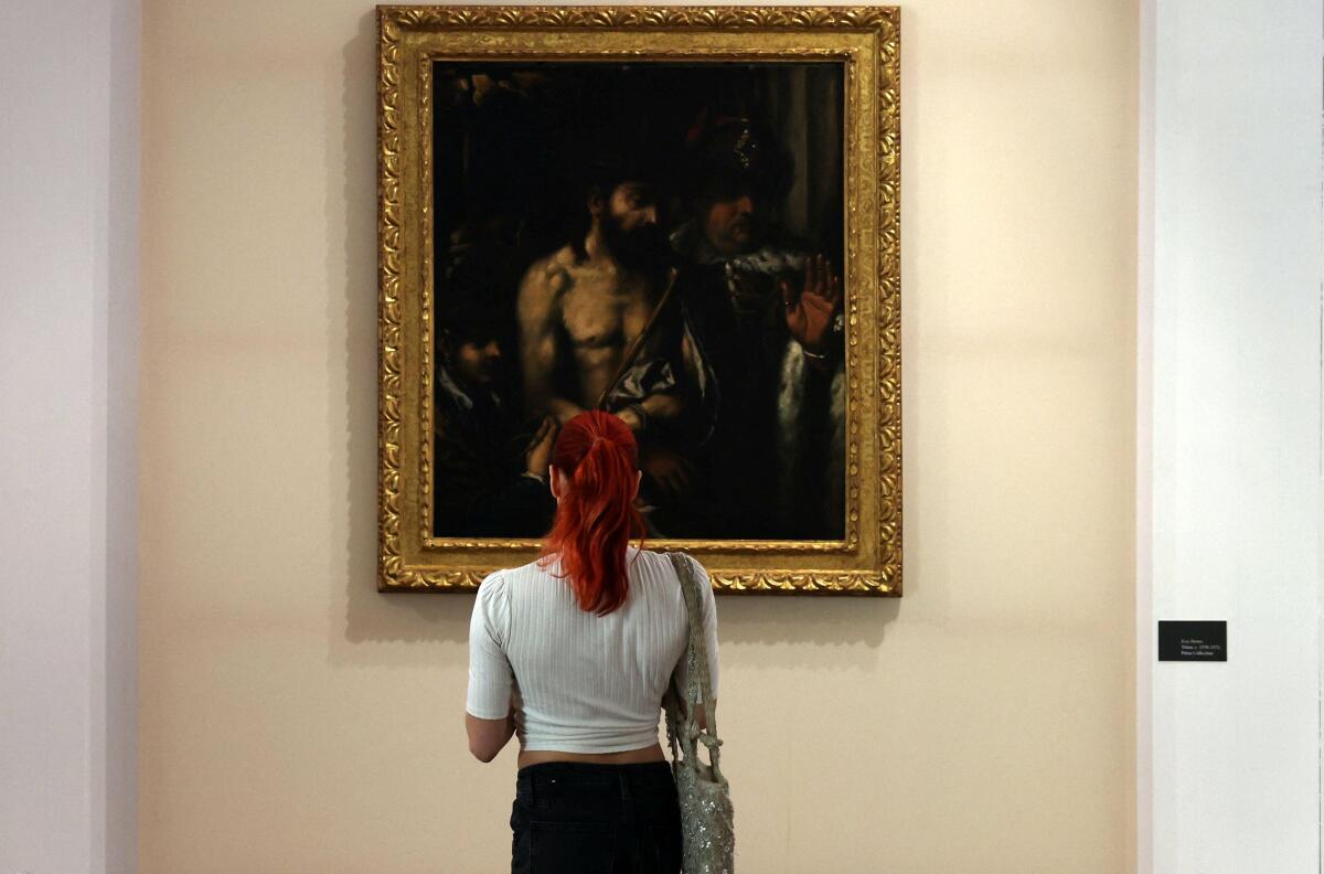 A visitor watches the Ecce Homo painting produced by Titian at the Limassol Municipal Arts Center in Limassol