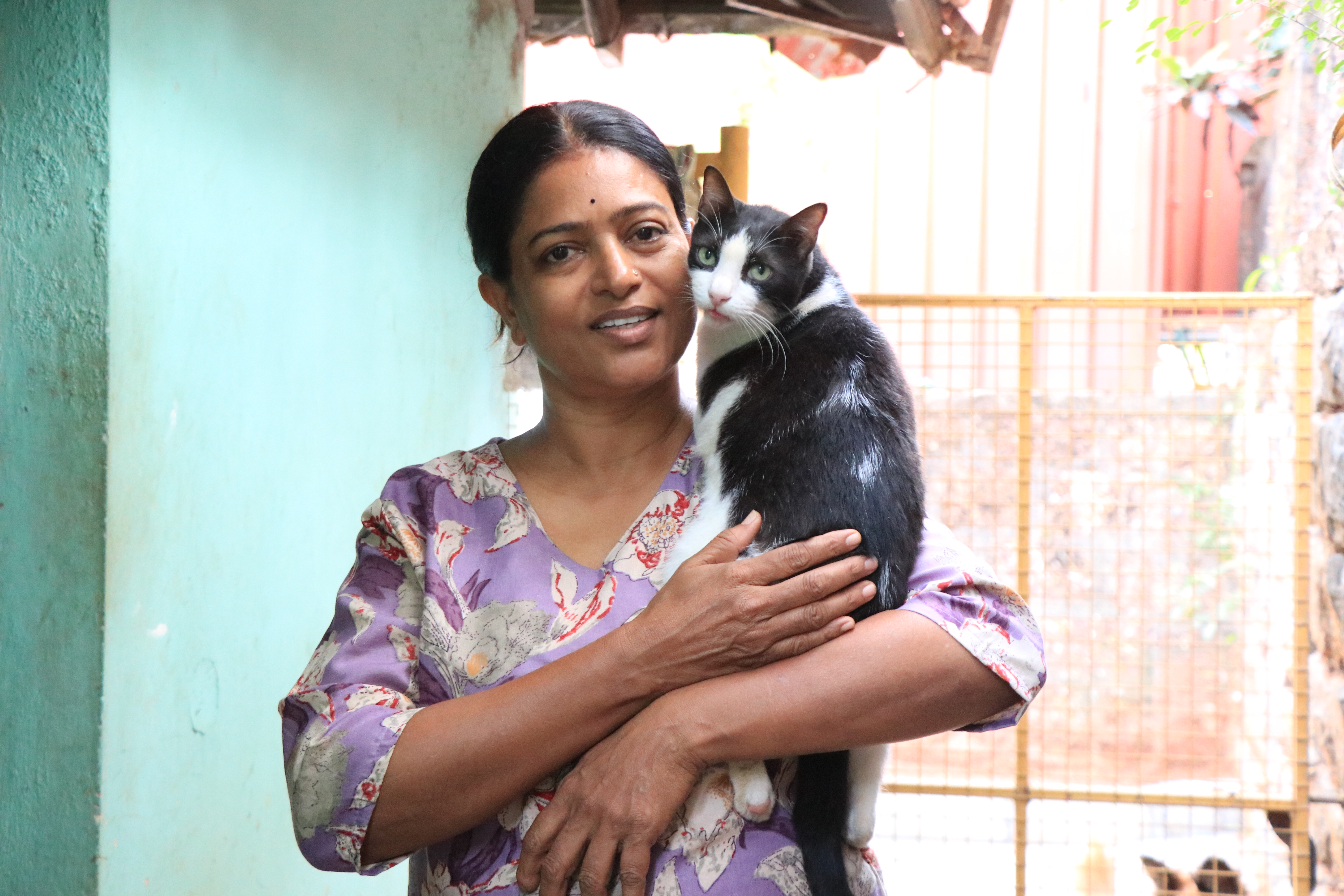 ; Usha with a cat in her care. 