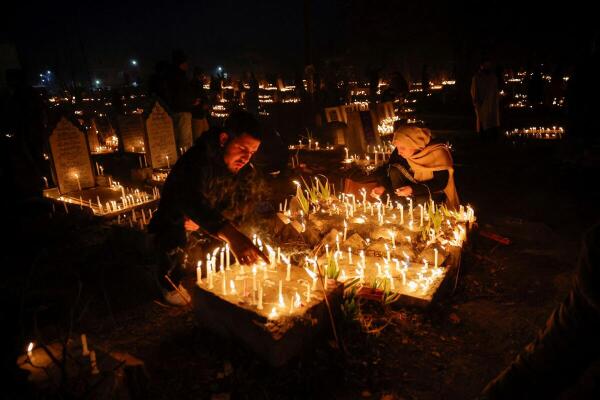 Kashmiri Shia Muslims pray and light candles on the graves of their family member while observing the Shab-e-Barat, the festival celebrated by seeking forgiveness and repenting, at a cemetery in Srinagar, February 13, 2025.