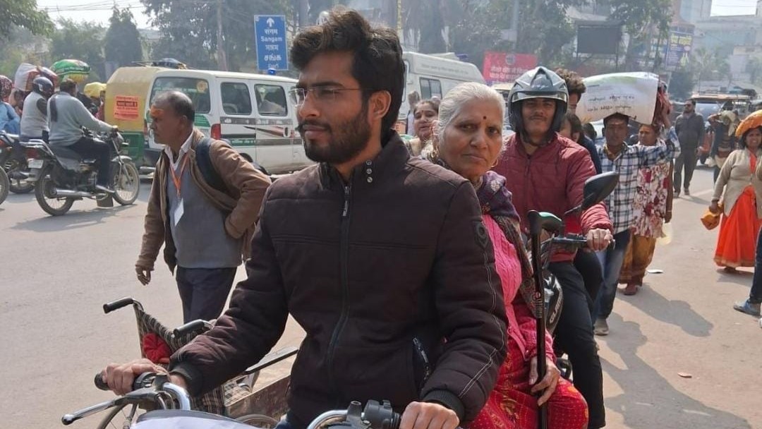 A person at the Maha Kumbh ferrying the elderly