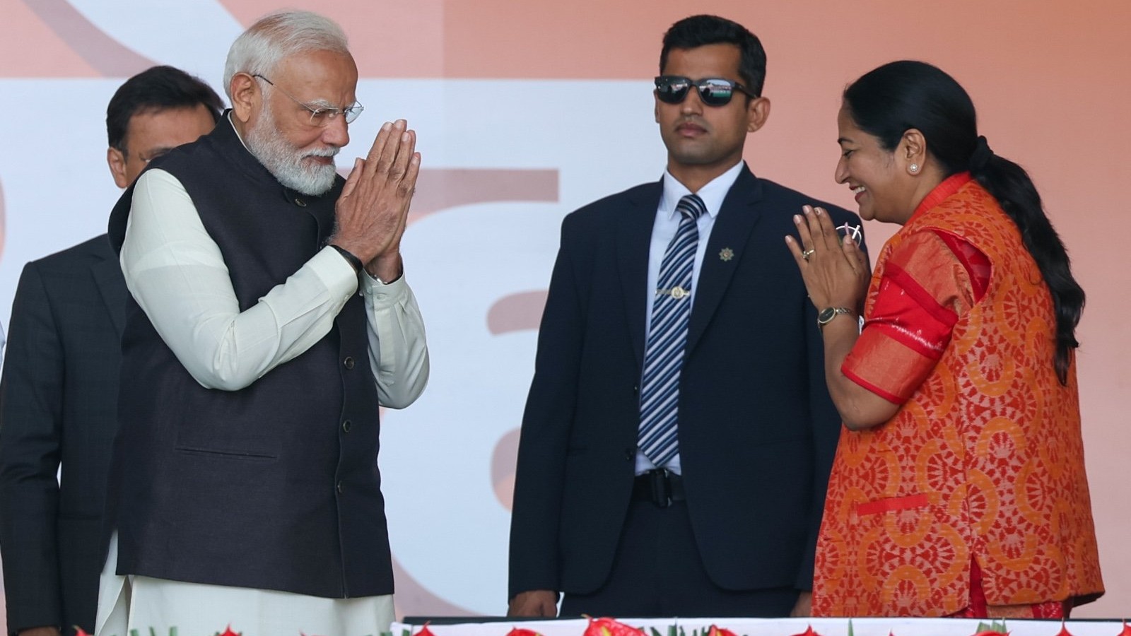 Prime Minister Narendra Modi exchanges greetings with newly sworn-in Delhi Chief Minister Rekha Gupta during a ceremony at Ramlila Maidan in New Delhi.