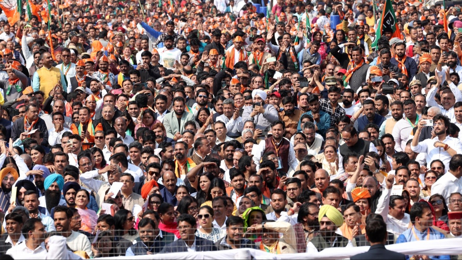 BJP supporters gather at the Ramlila Maidan for the oath ceremony of the Delhi Government in New Delhi.