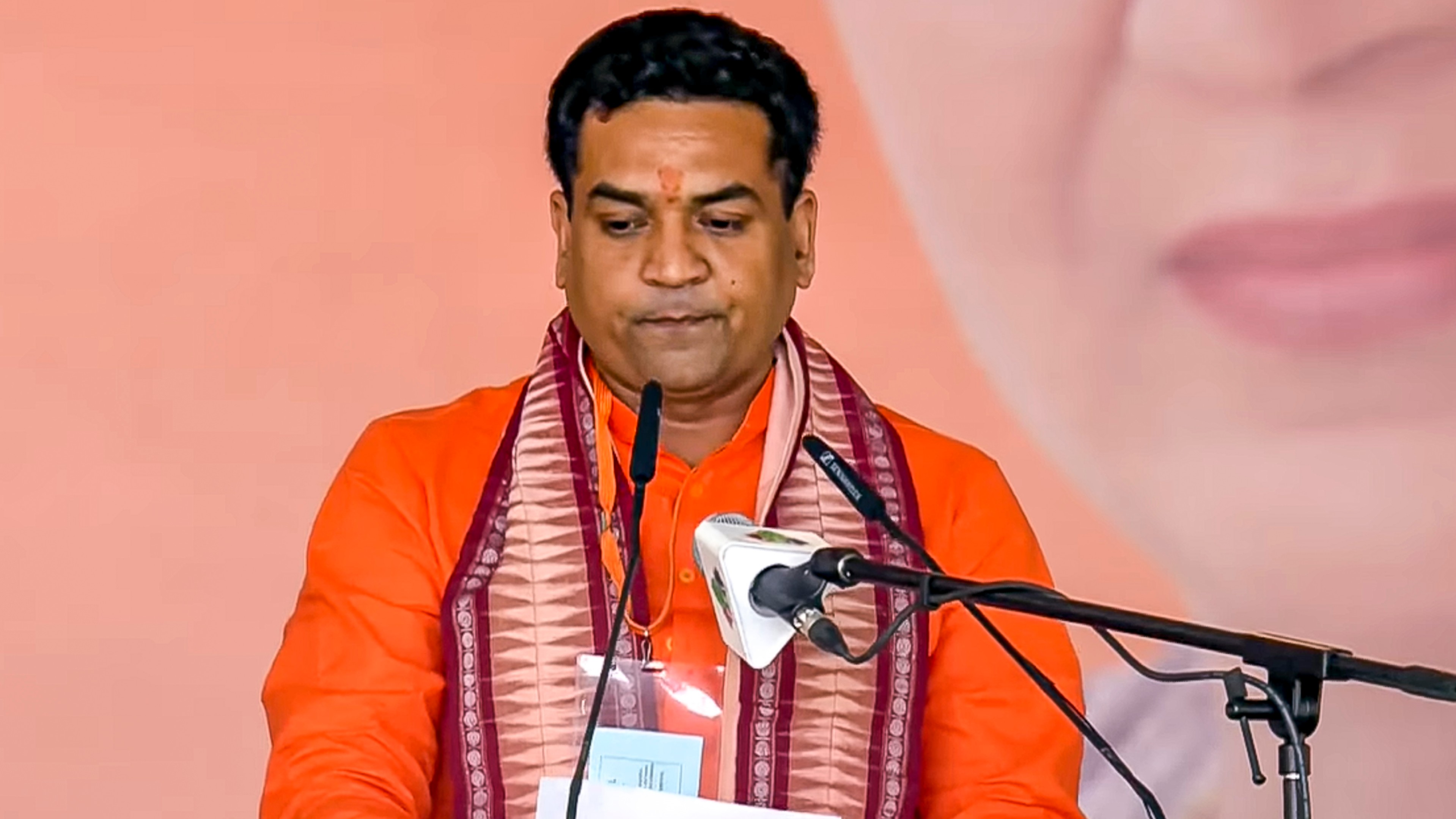 BJP MLA Kapil Mishra takes oath as a minister during the swearing-in ceremony of the Delhi government at Ramlila Maidan in New Delhi