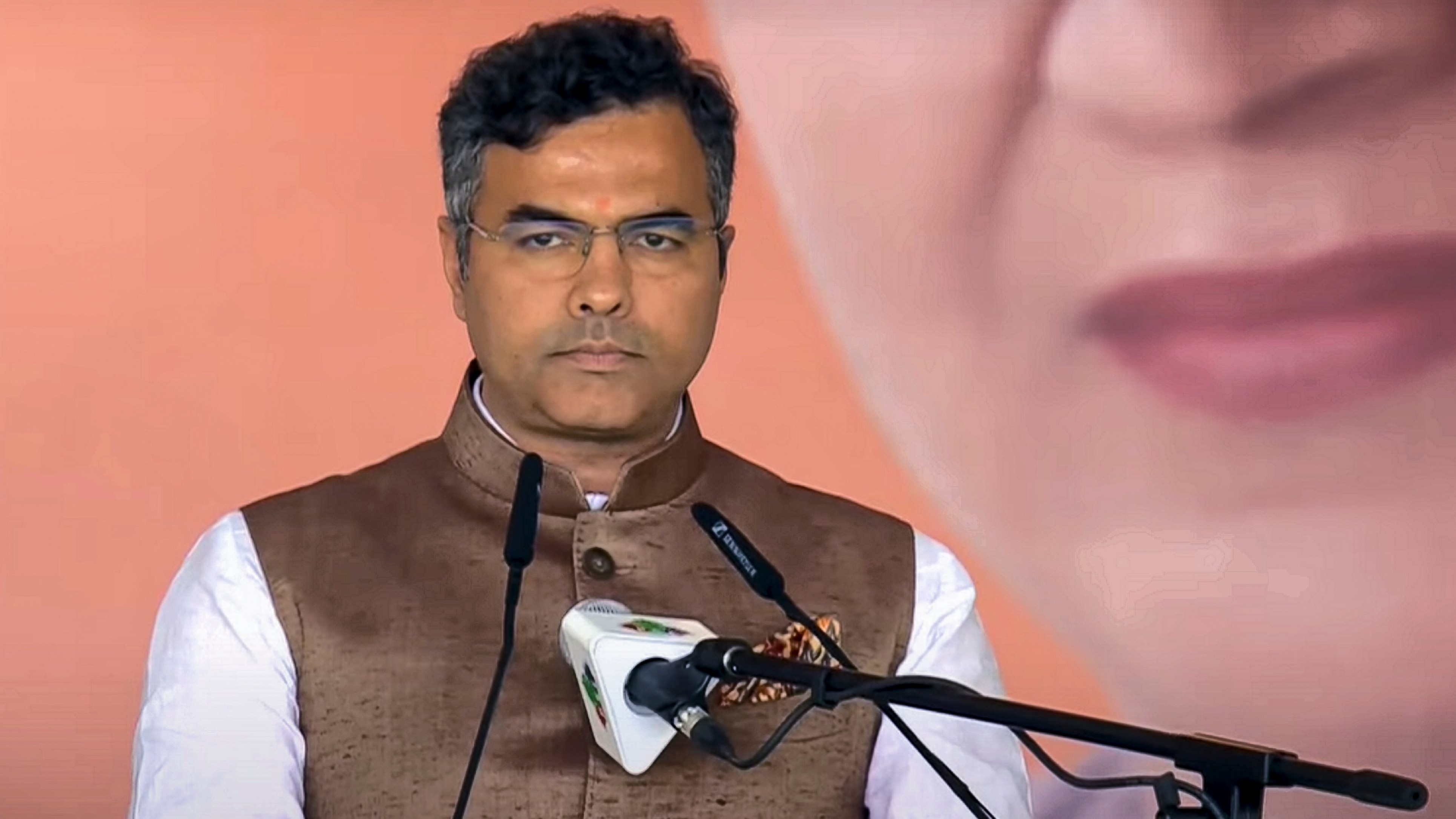 BJP MLA Parvesh Verma takes oath as a minister during the swearing-in ceremony of the Delhi government at Ramlila Maidan in New Delhi.