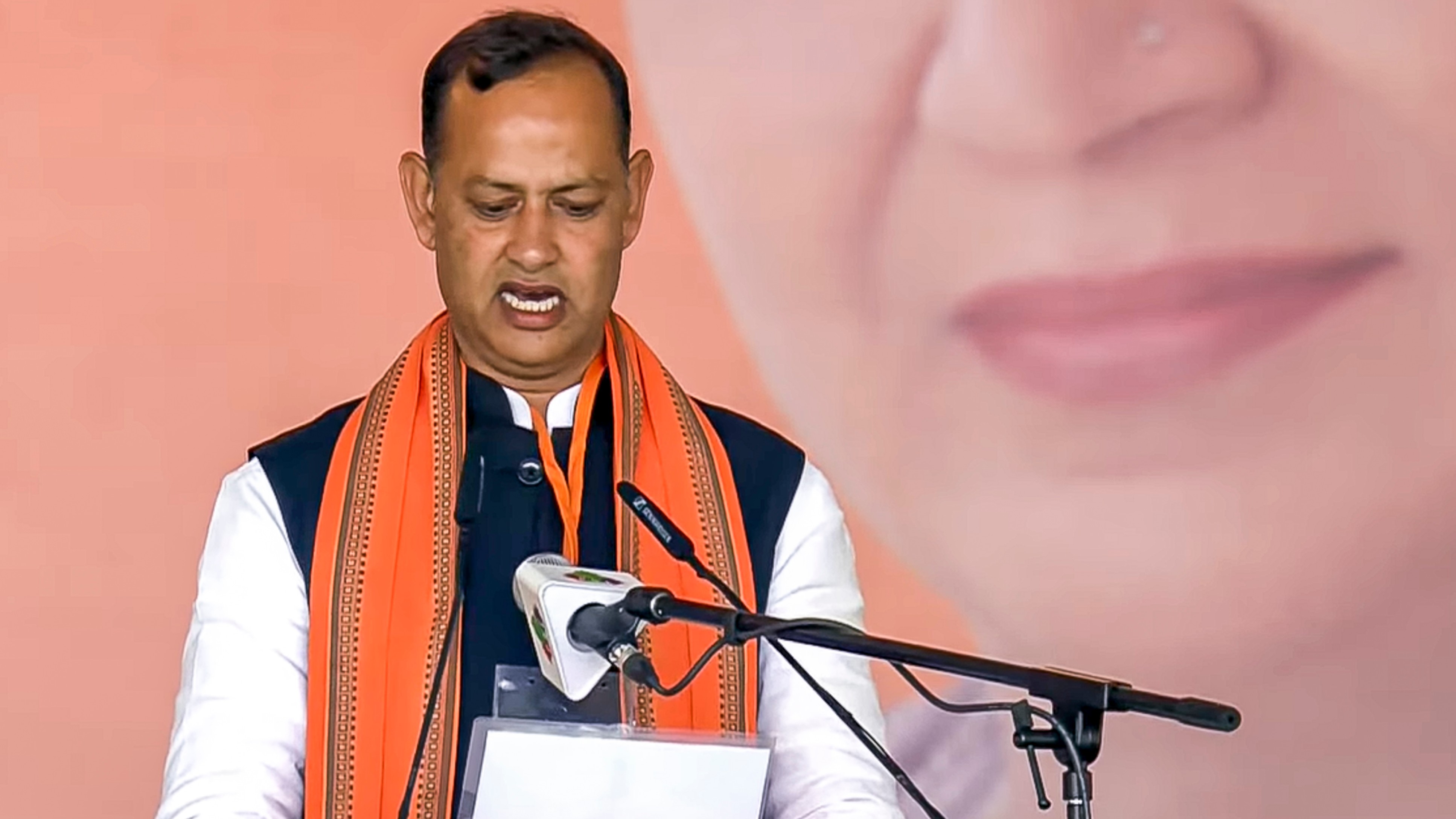 BJP MLA Ravinder Indraj Singh takes oath as a minister during the swearing-in ceremony of the Delhi government at Ramlila Maidan in New Delhi.