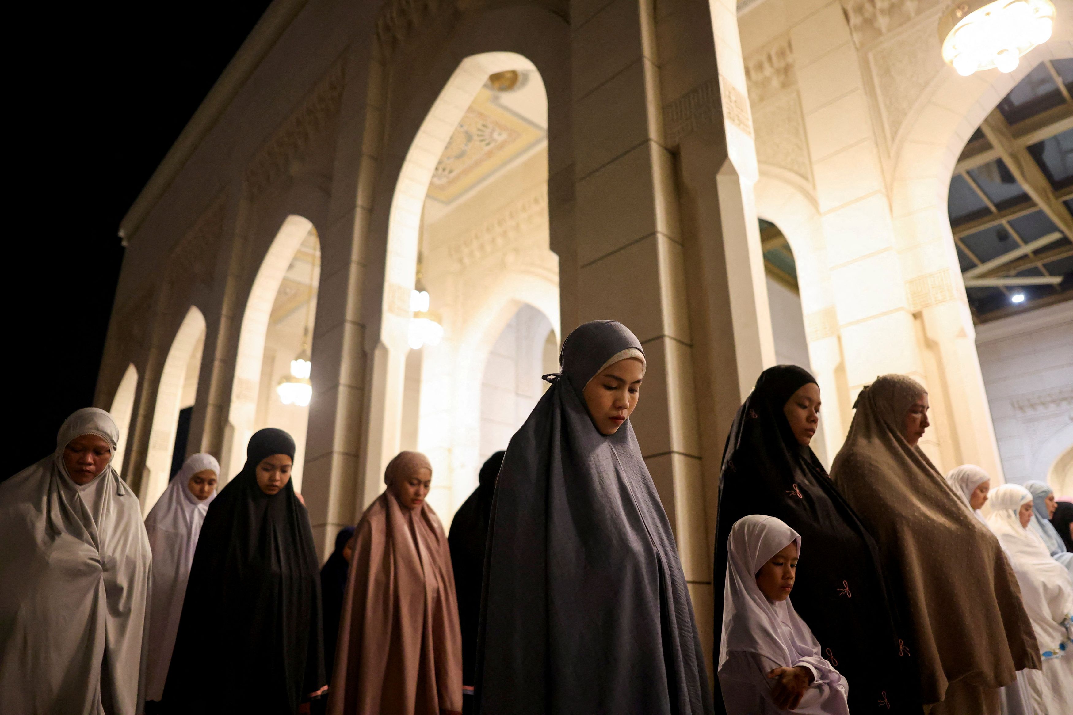 Muslim women perform the mass prayer of Tarawih during the first eve of the holy fasting month of Ramadan in Seremban, Malaysia.