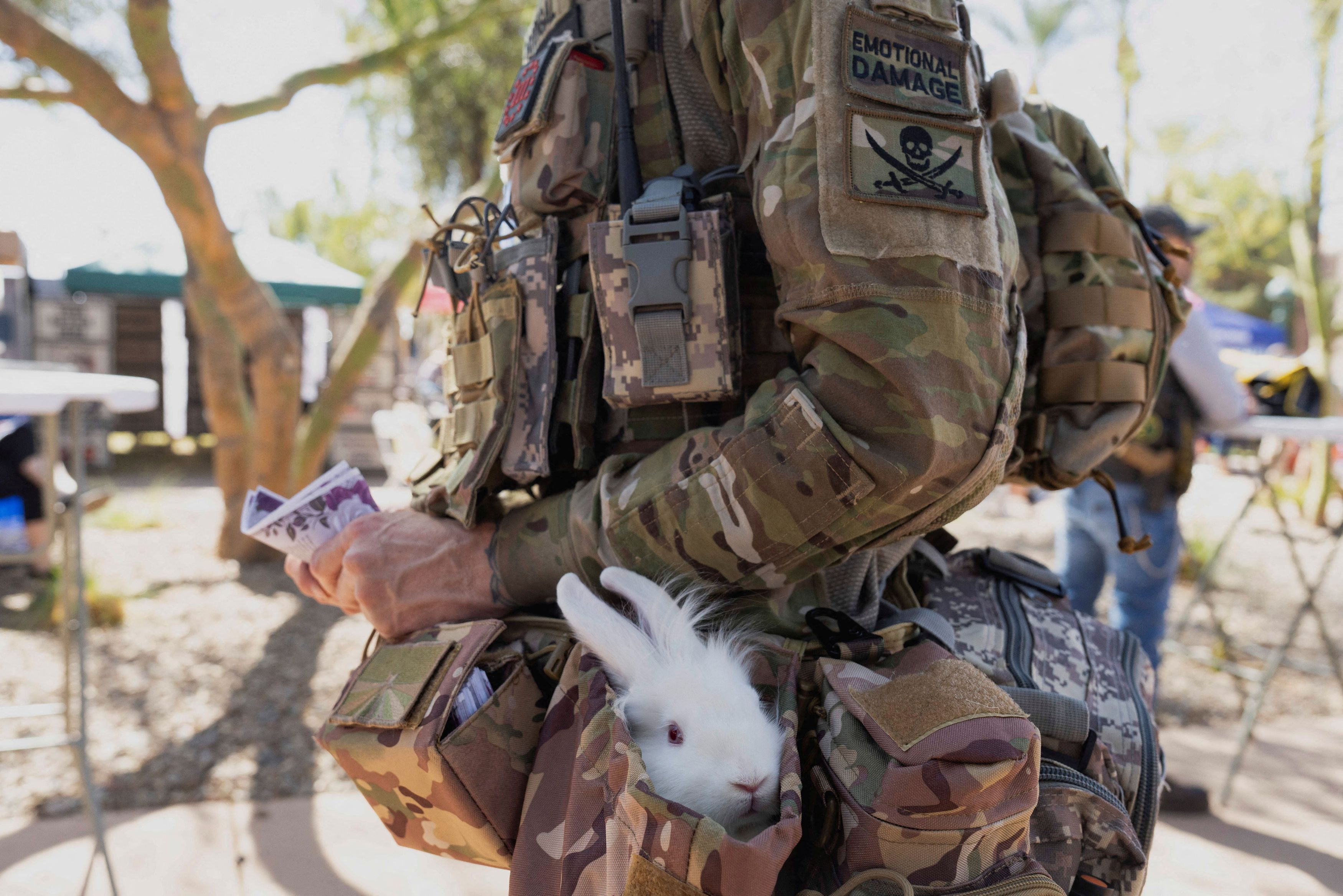 A man dressed in military fatigues carries a rabbit named Ranger during Gun Owners of America's Freedom Festival, a celebration of the Second Amendment to the US Constitution, at the Arizona State Capitol in Phoenix, Arizona.