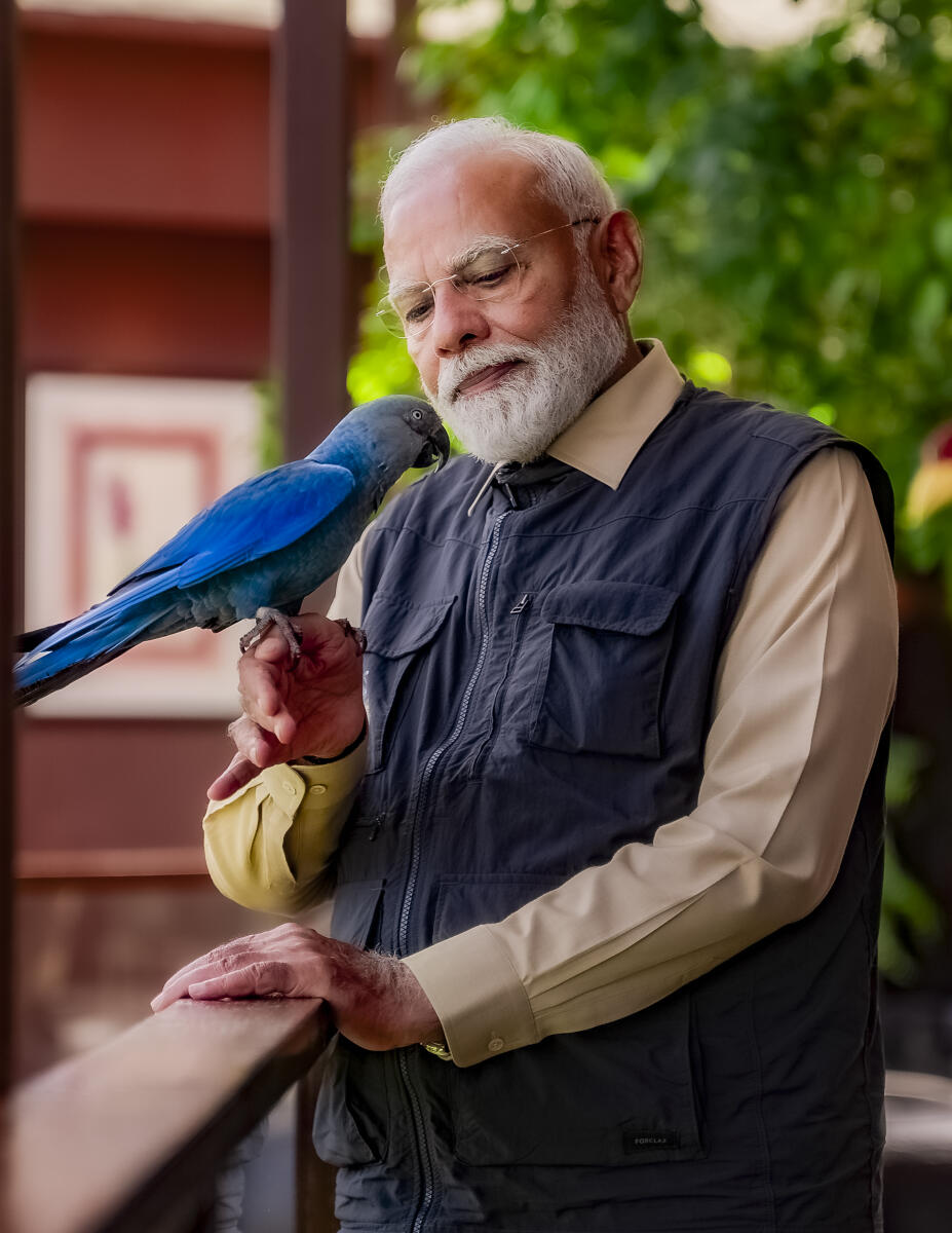 Prime Minister Narendra Modi interacts with a bird during the inauguration of 'Vantara', in Jamnagar, Gujarat.
