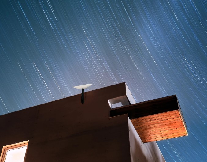 Starlink dish mounted at the top of the house.