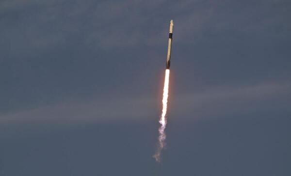 A SpaceX Falcon 9 rocket carrying a crew of four lifts off from Launch Complex 39-A.