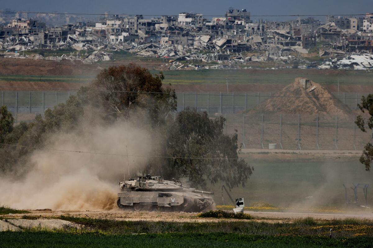 An Israeli tank manoeuvres on the Israeli side of the border between Israel and Gaza, March 18, 2025.