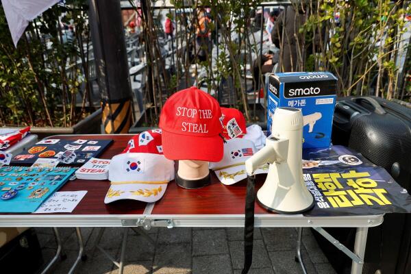 A megaphone, hats, stickers and pins lie on a table as far-right demonstrators gather while waiting for the Constitutional Court ruling on President Yoon Suk Yeol's impeachment, near his residence in Seoul, South Korea.