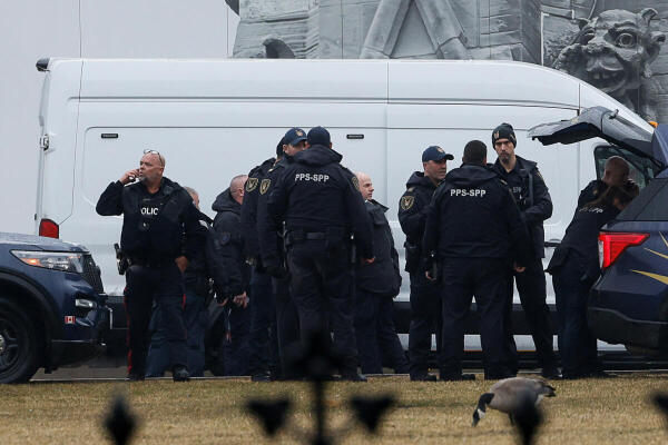 Canadian Parliamentary Protective Service officers stand together, as Police secure the perimeter of Canada's Parliament after declaring a lockdown, in Ottawa.
