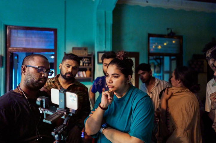 Filmmaker Shalini Vijayakumar (center) and cinematographer Vighneshwar (background left) review footage on the set of Seeing Red, Vijayakumar’s short film for MAMI Select: Filmed on iPhone.