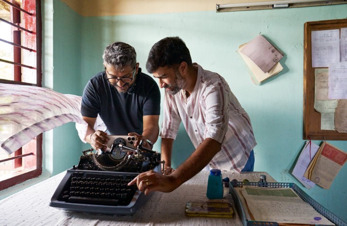 Rohin Raveendran Nair (right), on set with cinematographer Swapnil S. Sonawane (left), frames a POV shot from inside of a typewriter using iPhone 16 Pro Max while filming Kovarty.