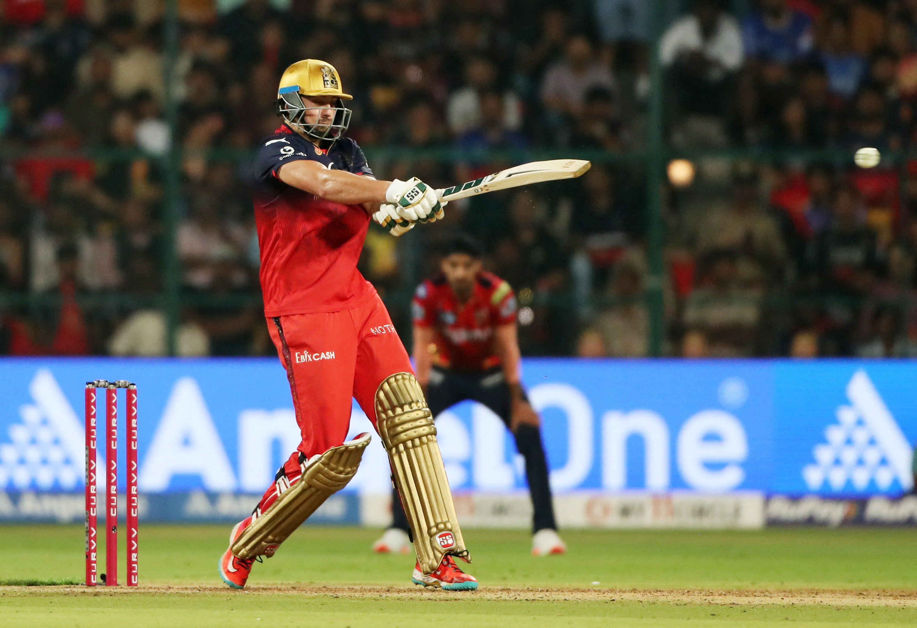 Following a top-order collapse Tim David rescued RCB with an unbeaten 50 at the M Chinnaswamy Stadium in Bengaluru on Friday. REUTERS