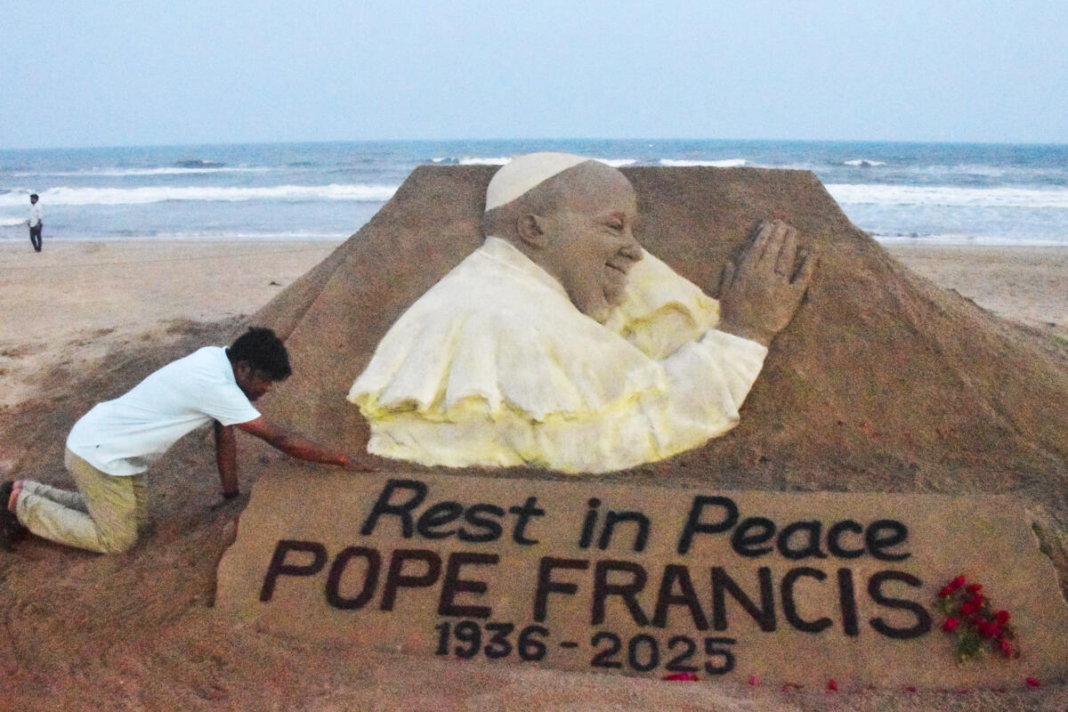 Sand artist Sudarsan Pattnaik creates a sand sculpture of Pope Francis to pay him tribute, at the Puri Beach, Odisha