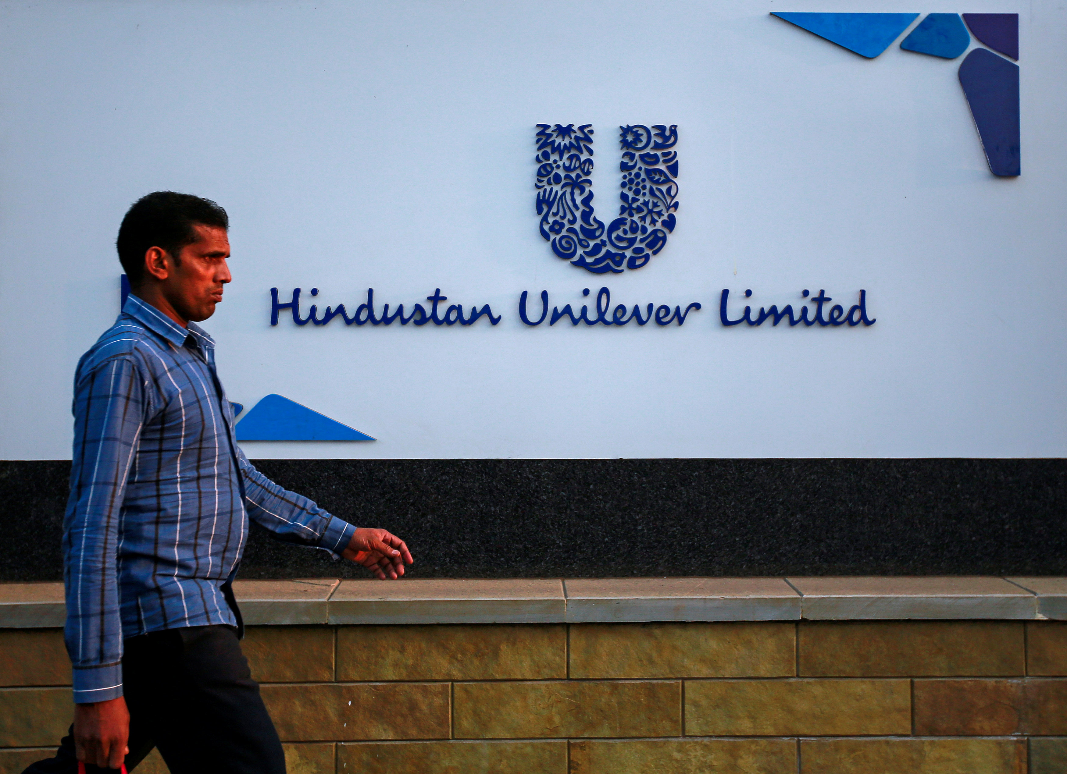 FILE PHOTO: A pedestrian walks past the Hindustan Unilever Limited (HUL) headquarters in Mumbai January 19 2015. 