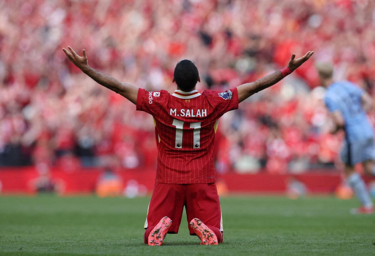 Liverpool's Mohamed Salah celebrates after winning the Premier League. 