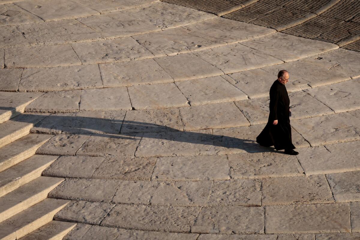 A priest walks at St. Peter's Square, ahead of the funeral Mass of Pope Francis, at the Vatican, April 26, 2025.
