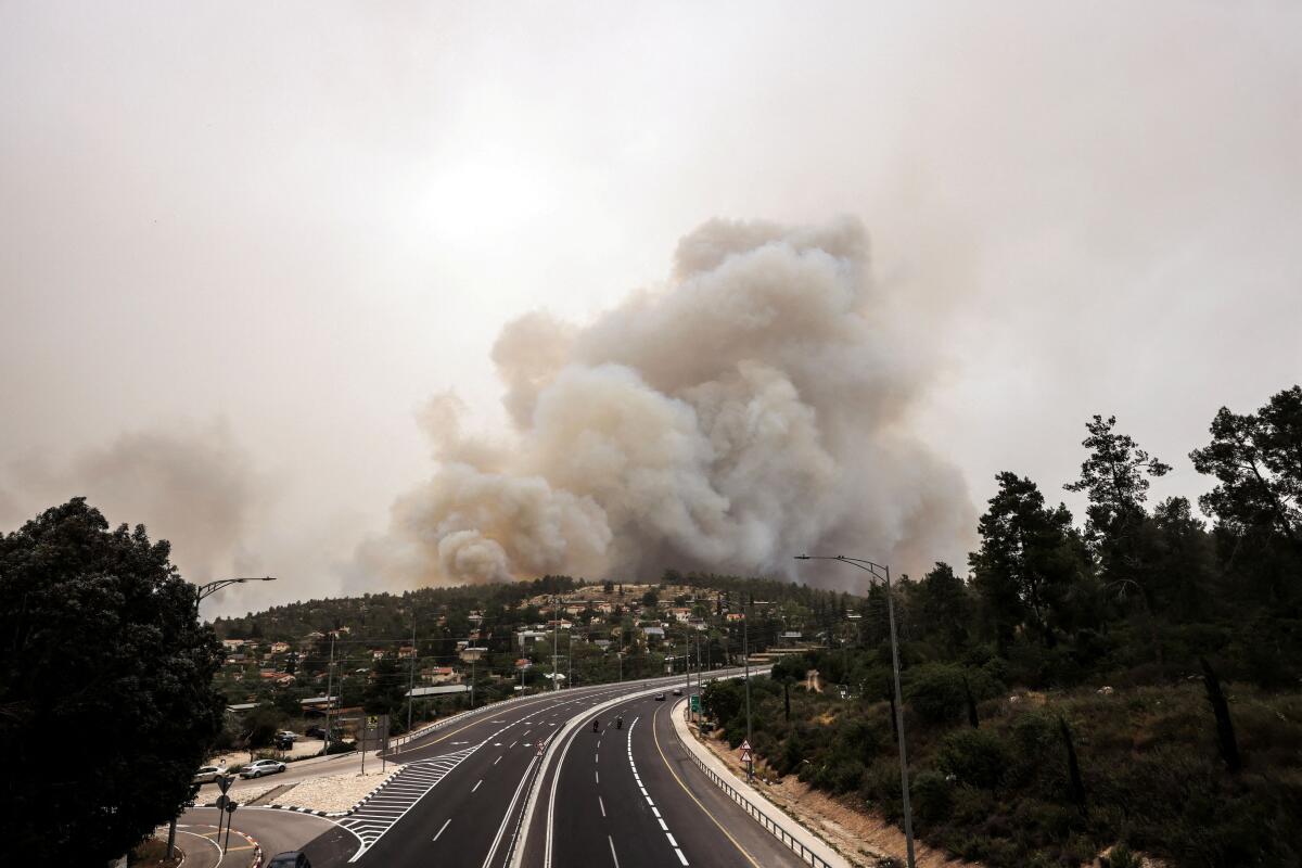 Smoke rises near Latrun, as wildfires due to extreme heat and winds broke out in central Israel, April 30, 2025.