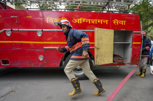 Firemen during a mega civil defence mock drill 'Operation Abhyaas' at Khan Market, in New Delhi