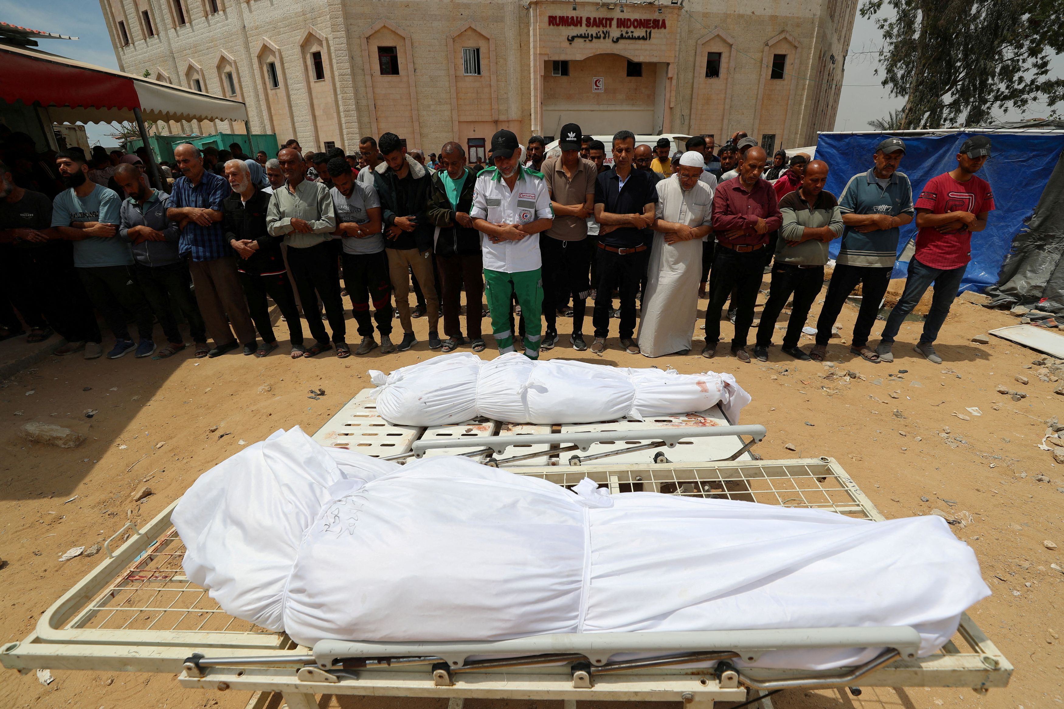 Mourners attend the funeral of Palestinians killed in Israeli strikes, at the Indonesian hospital in Beit Lahia, in the northern Gaza Strip