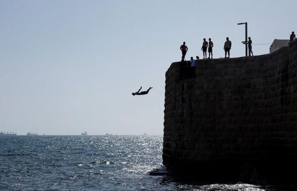 A man jumps into the Mediterranean Sea, in the northern Israeli city of Acre.