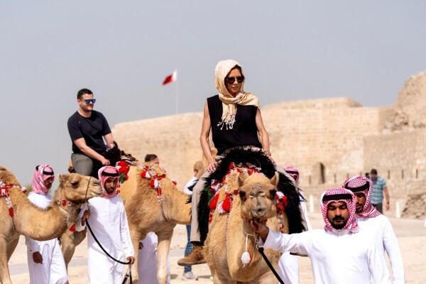 US Homeland Security Secretary Kristi Noem rides a camel after a tour of Qal'at al-Bahrain Fort.