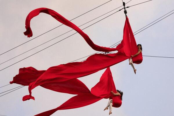 Dancers from the Cia K dance company perform an aerial circus act while suspended from a zipline during the 'Virada Cultural' event in downtown Sao Paulo, Brazil.