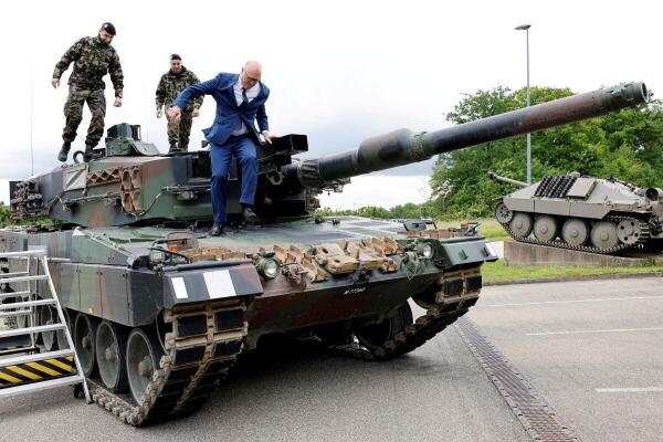 Swiss Federal Councillor Martin Pfister stands on a LEO 2 tank, as he visits Swiss army troops in Bure, Switzerland.