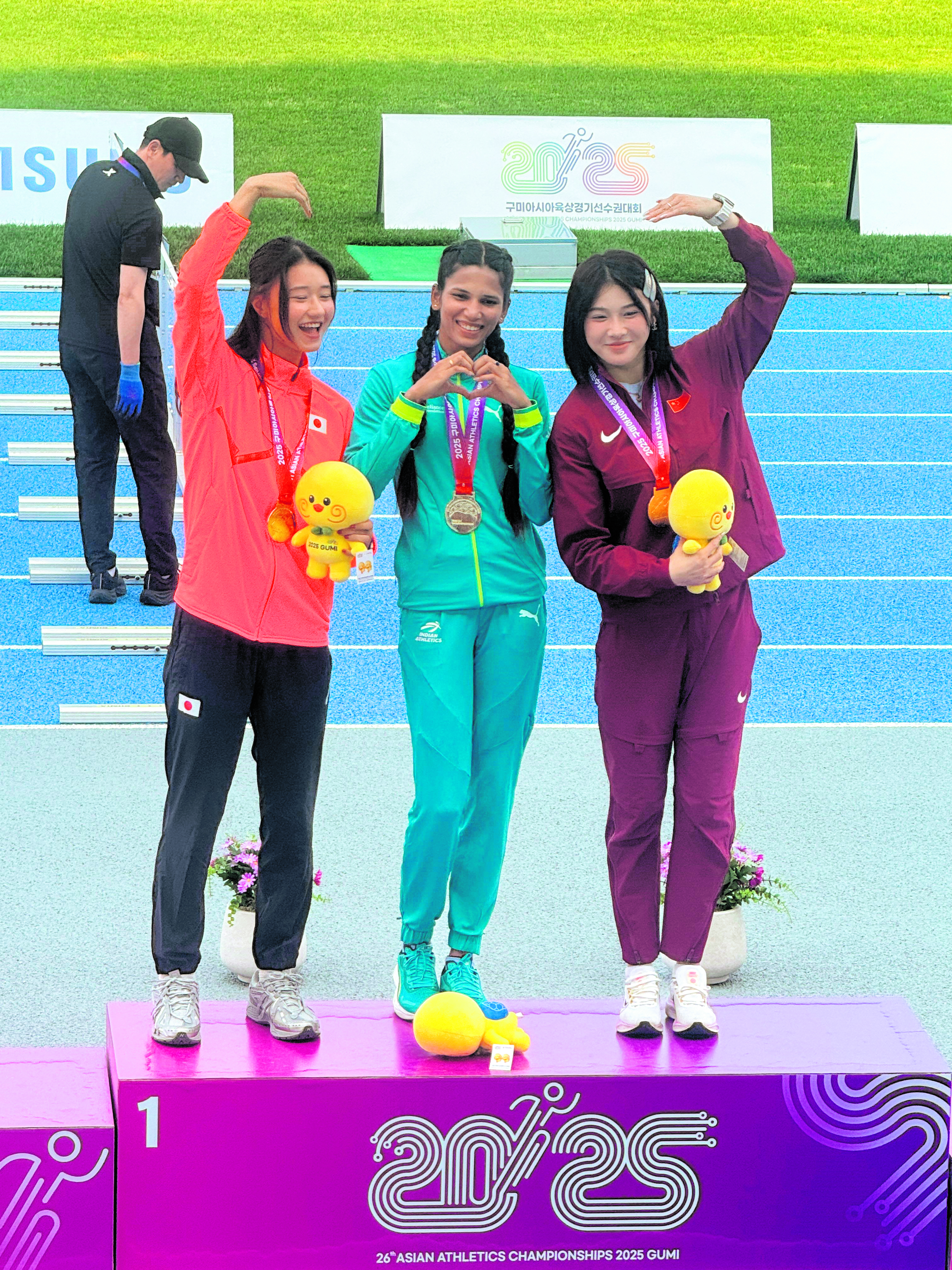 Jyothi Yarraji (centre) is all smiles on the podium after winning gold in the 100m hurdles with a meet record time of 12.96 seconds at the Asian Athletics Championships in Gumi South Korea on Thursday. AAC MEDIA