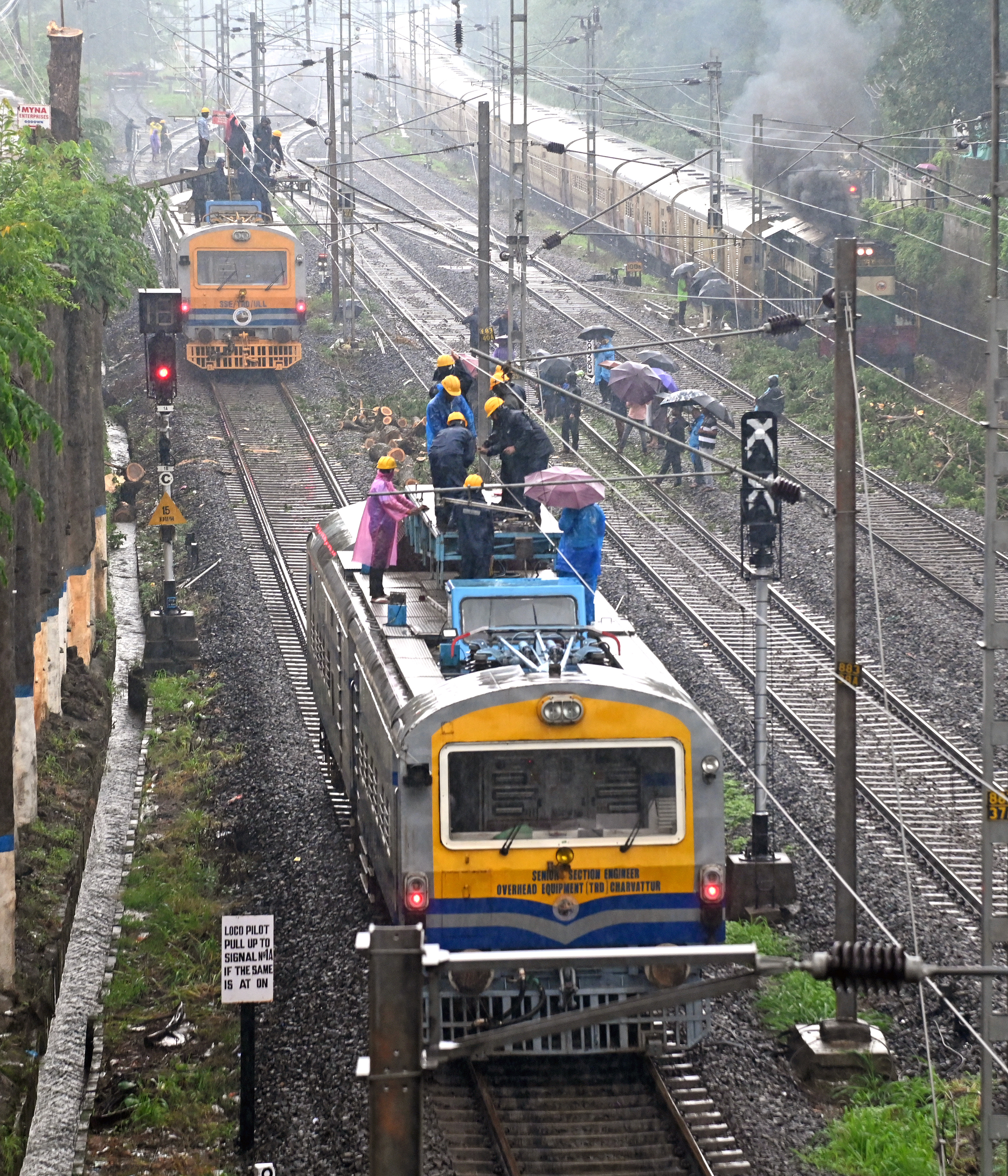 Railway personnel restore their infrastructure after it was damaged due to rainfall in Mangaluru. DH Photos/Fakruddin H