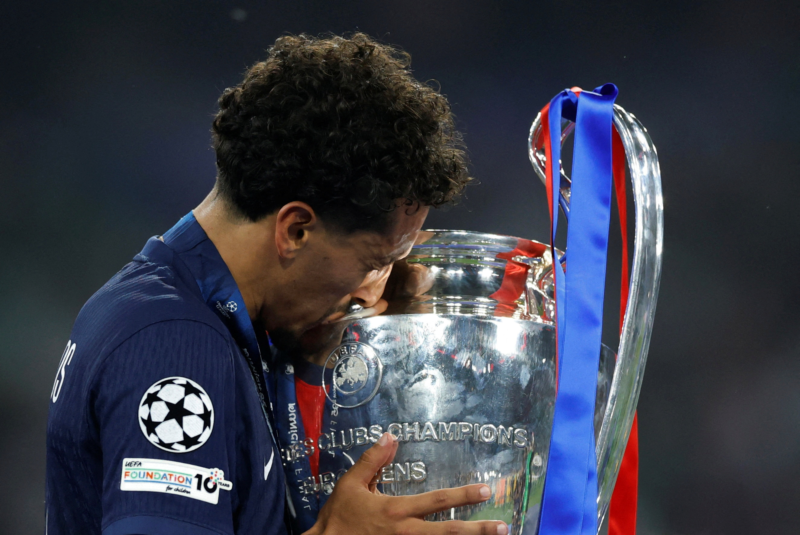  Paris St Germain's Marquinhos celebrates with the trophy after winning the Champions League.