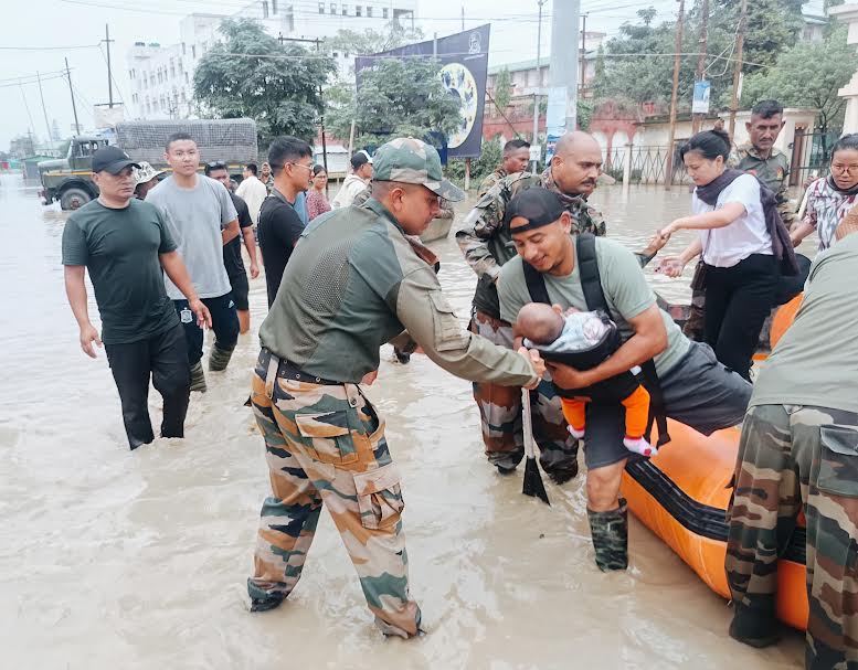 Army personnel rescuing flood-hit people in Manipur capital Imphal on Monday.