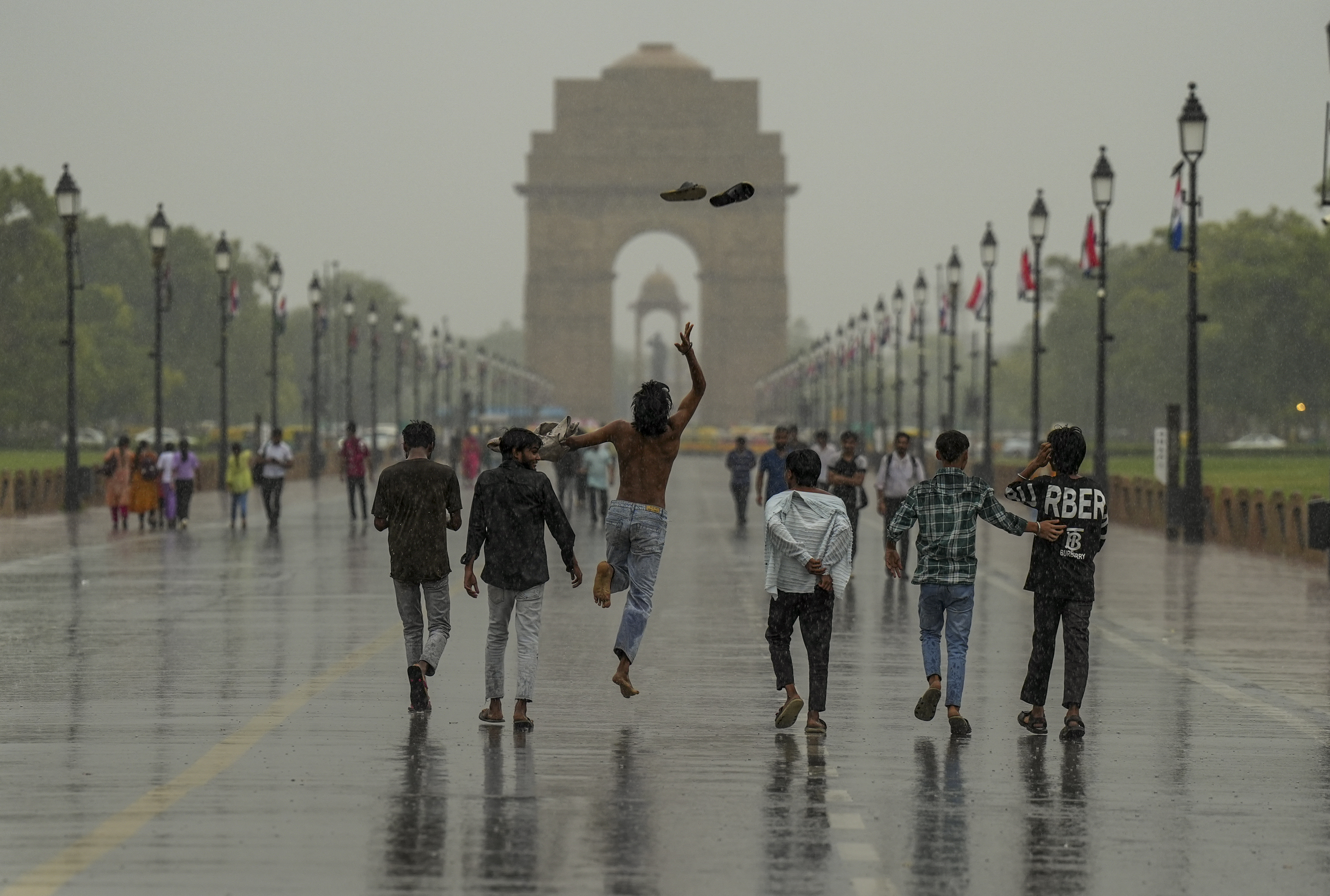 Visitors at Kartavya Path during rain, in New Delhi.