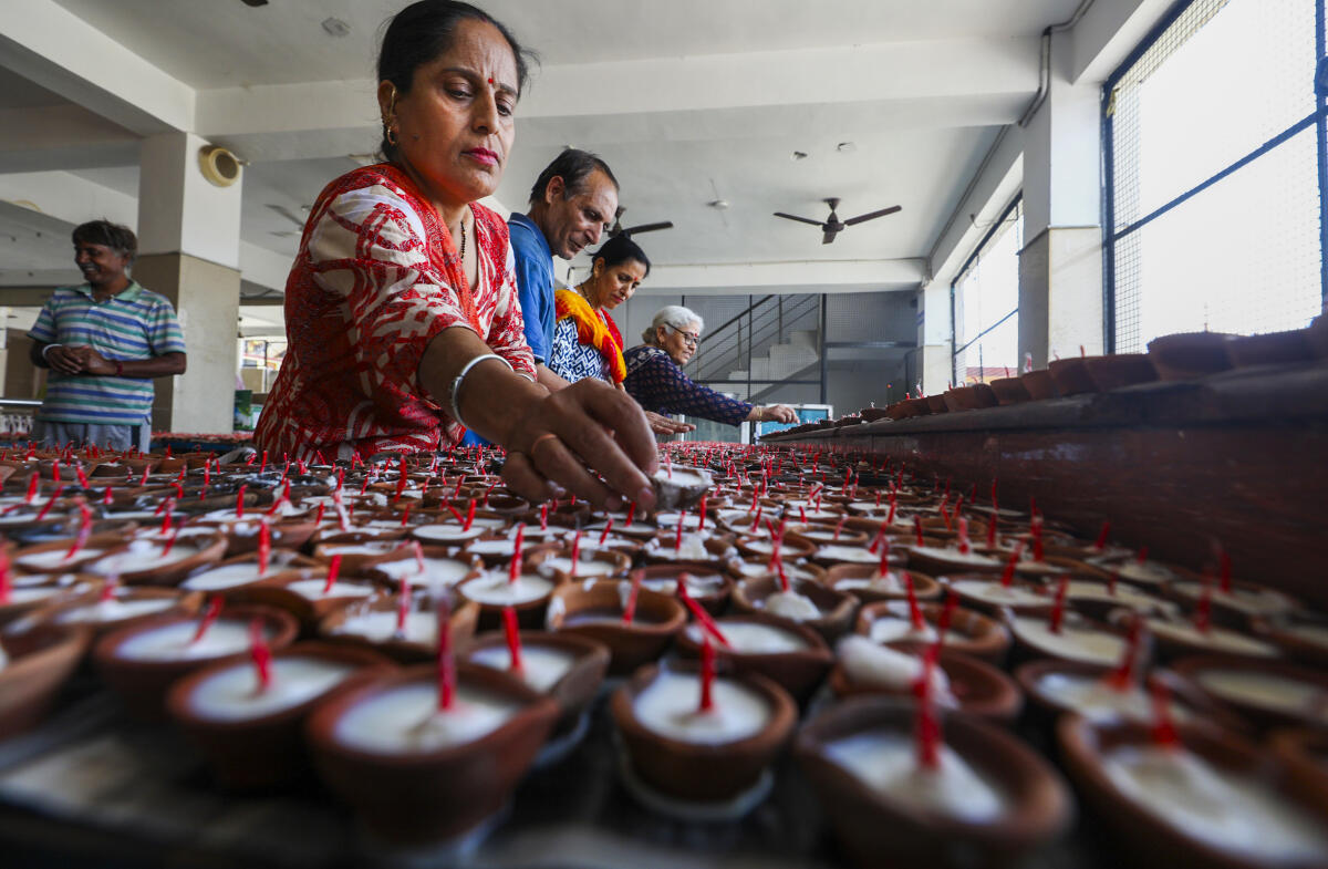 Kashmiri devotees arrange earthen lamps on the eve of the 'Kheer Bhawani Mela', at Janipur, in Jammu