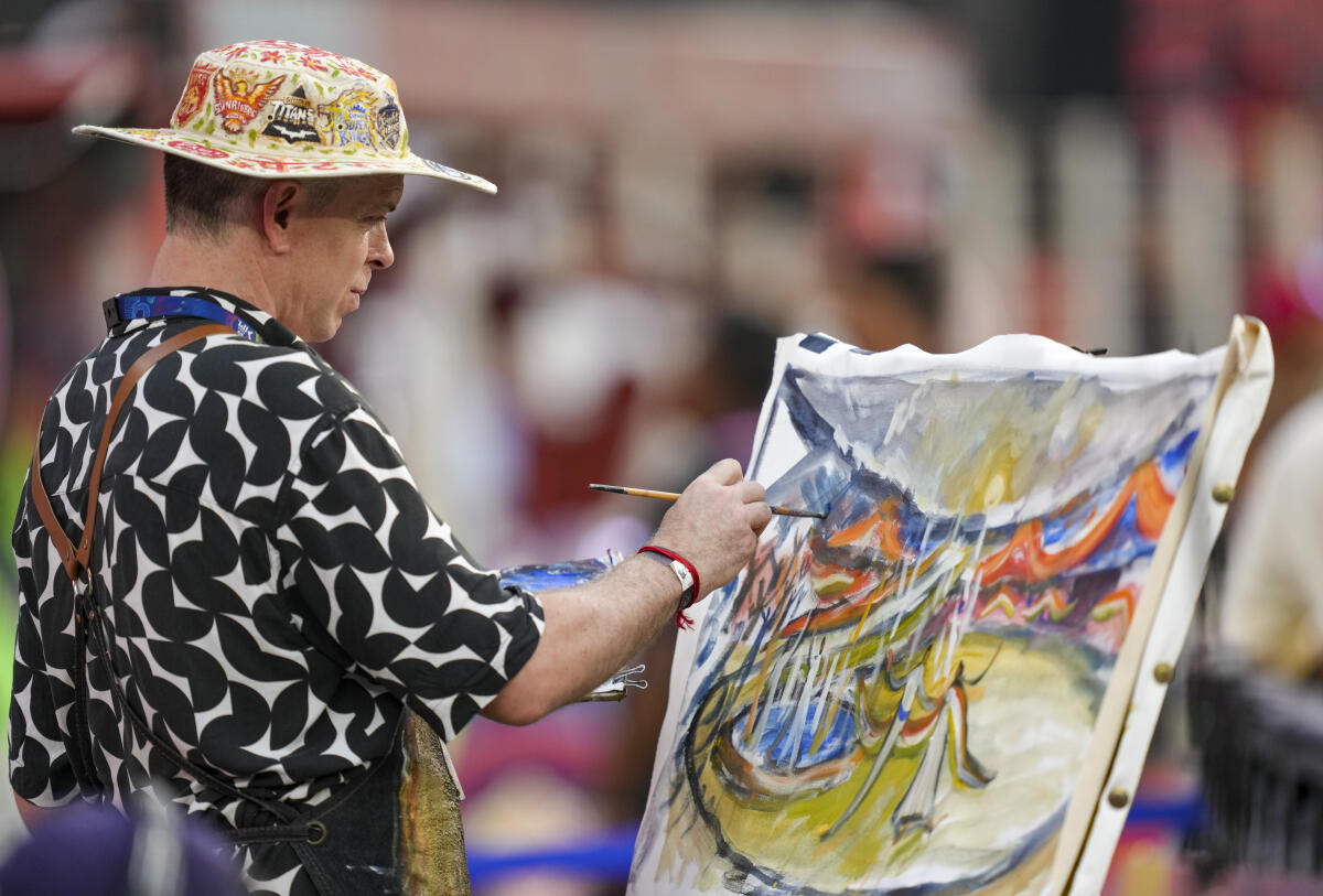 An artist makes a live painting during the Indian Premier League (IPL) 2025 T20 final cricket match between Royal Challengers Bengaluru and Punjab Kings, at the Narendra Modi Stadium, in Ahmedabad
